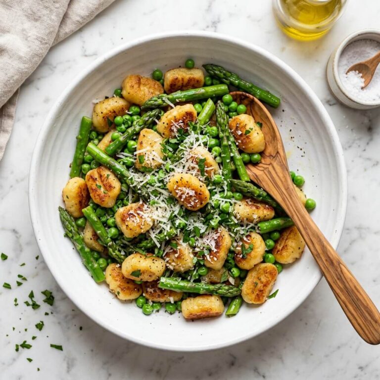 Crispy Gnocchi with Asparagus and Peas Recipe - Crispy Gnocchi with Asparagus and Peas Recipe served in a white bowl overhead view